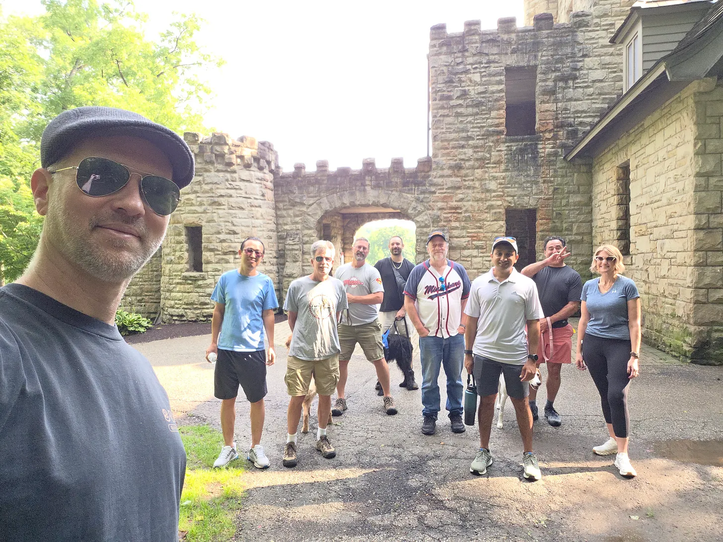 CLE AI and Data members and their dogs gathered in front of Squire's Castle in Willoughby Hills for the August 2026 community hike